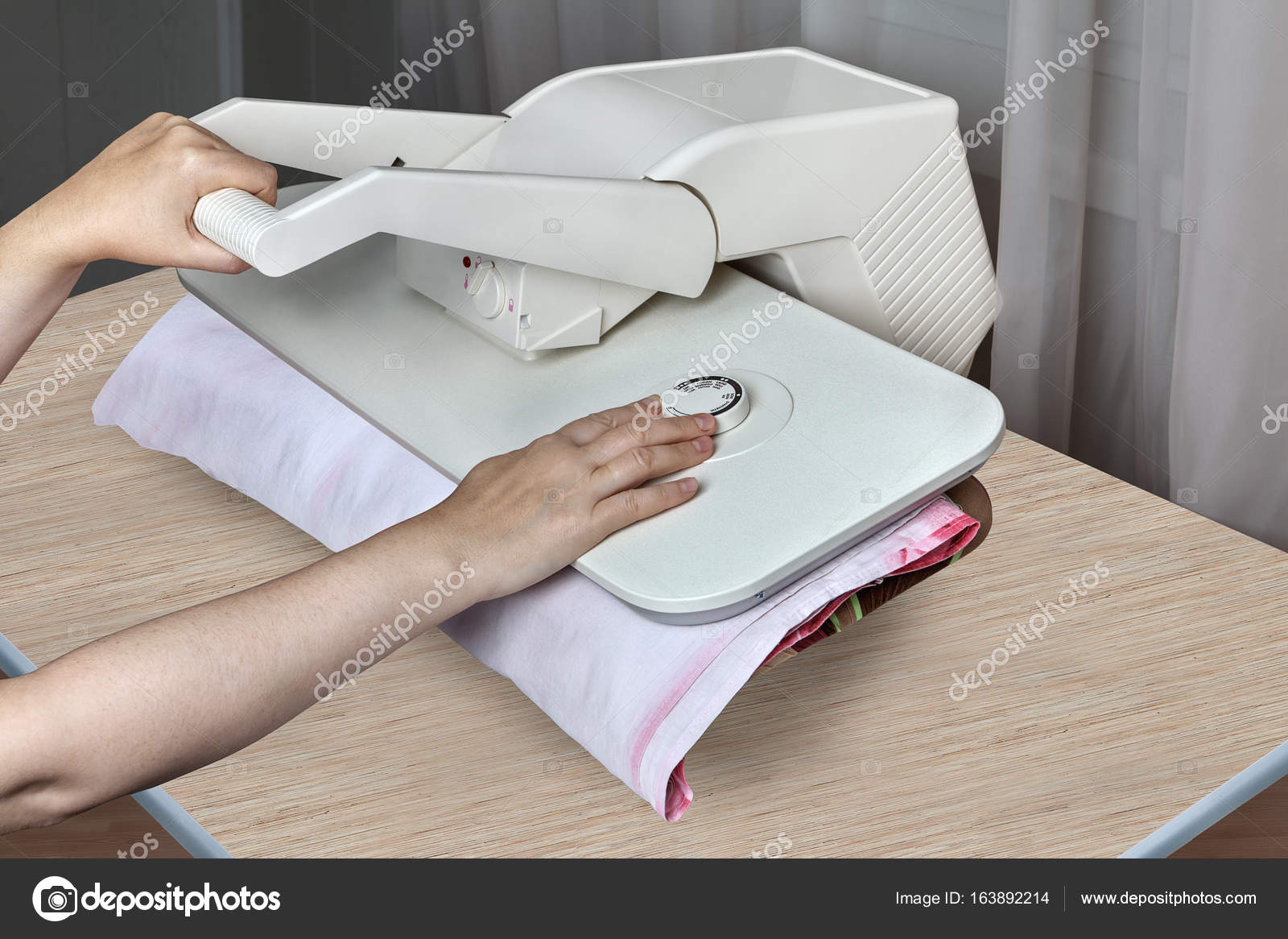 Steam press machine for home, female hands iron bed linens. Stock Photo by  ©grigvovan 163892214